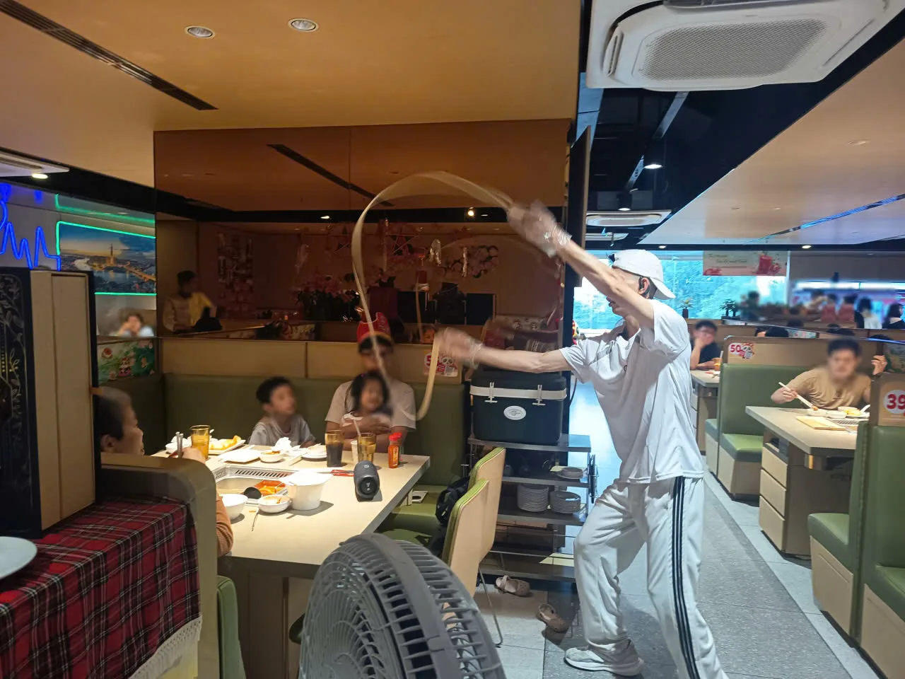Màn múa mì trong khung giờ vàng tại Haidilao Đồng Khởi, khách ở bàn bên cạnh đội vương miện theo dõi