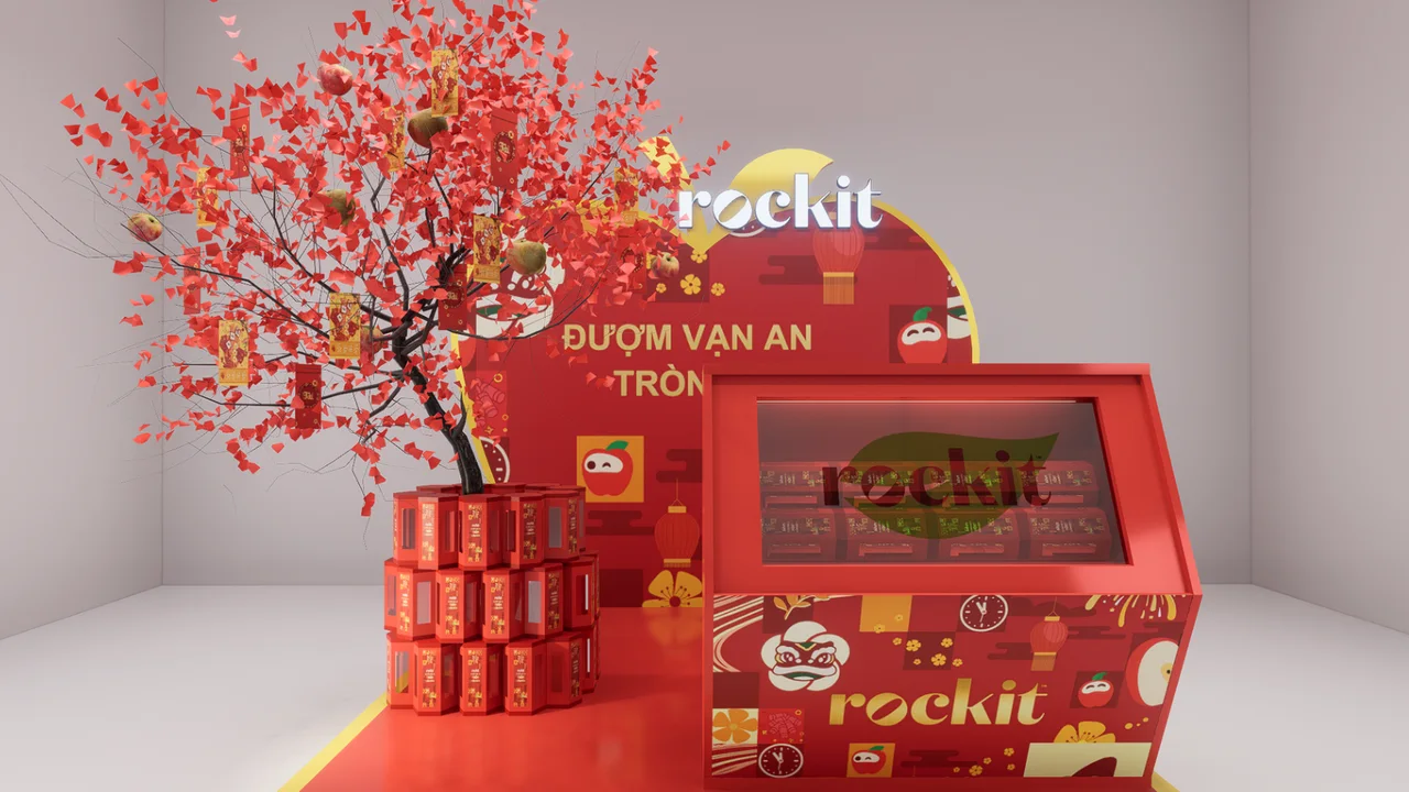 Phối cảnh đề xuất booth Vườn An Rockit với cây Vạn An treo táo và bao lì xì, quầy trưng bày hộp quà